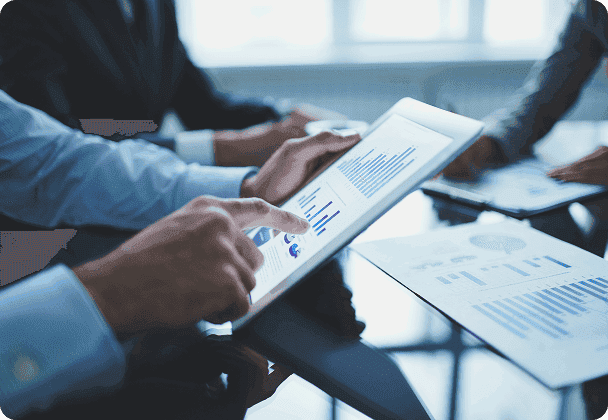 People reviewing charts on a tablet in a meeting